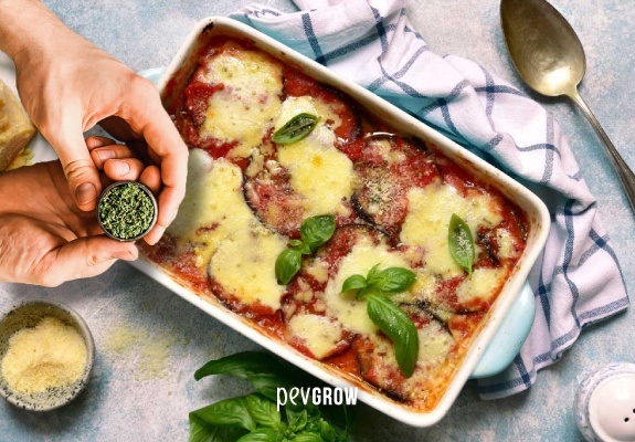 Image of a tray with Baked Italian Eggplant with a touch of weed