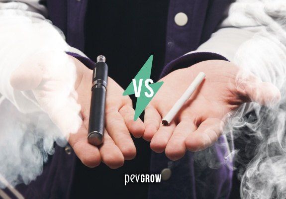 Image of a person with a cigarette in one hand and a vaporizer in the other hand.