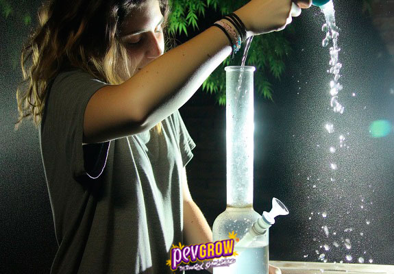 Image of a girl filling a bong with water